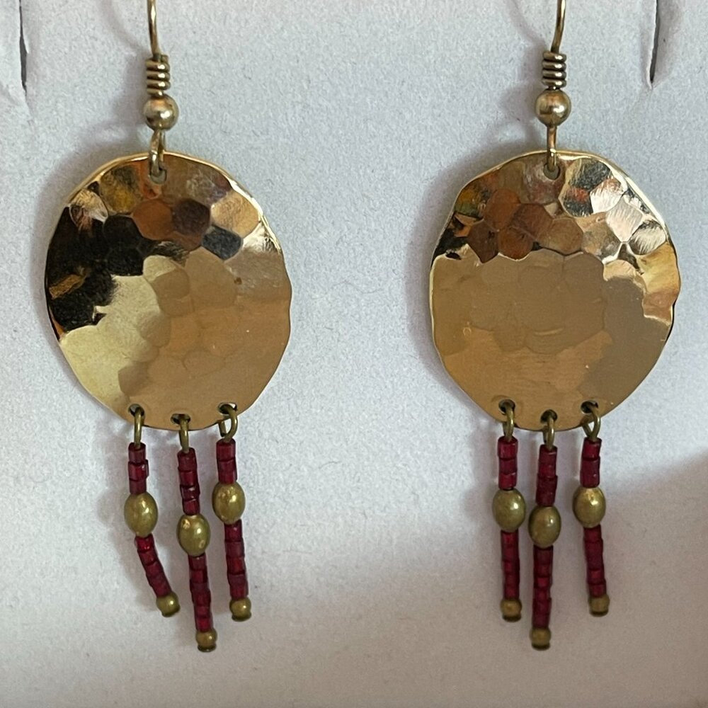 Vintage Bohemian-chic hammered brass dangle earrings with red bead fringes.